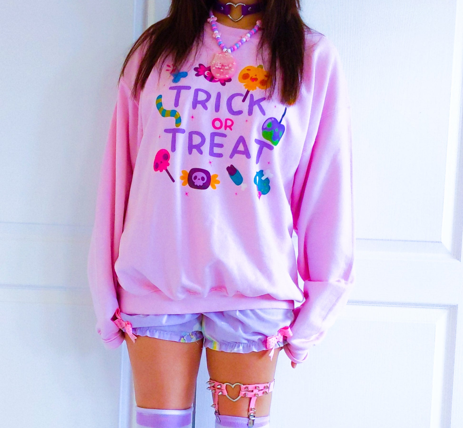Girl modelling a Kawaii Cute Halloween sweatshirt with spooky candies design
