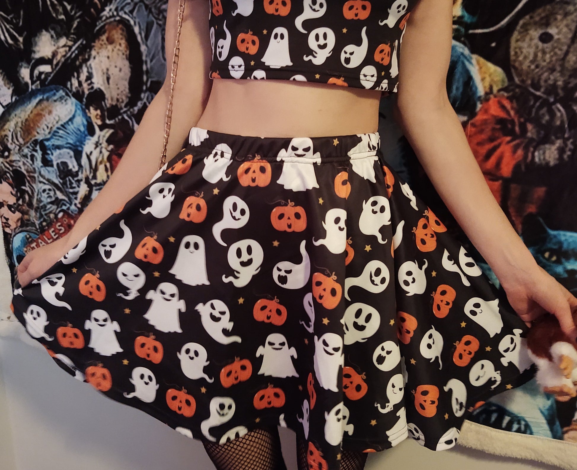 Young girl wearing a pastel goth Halloween skirt with pumpkin ghosts desing.