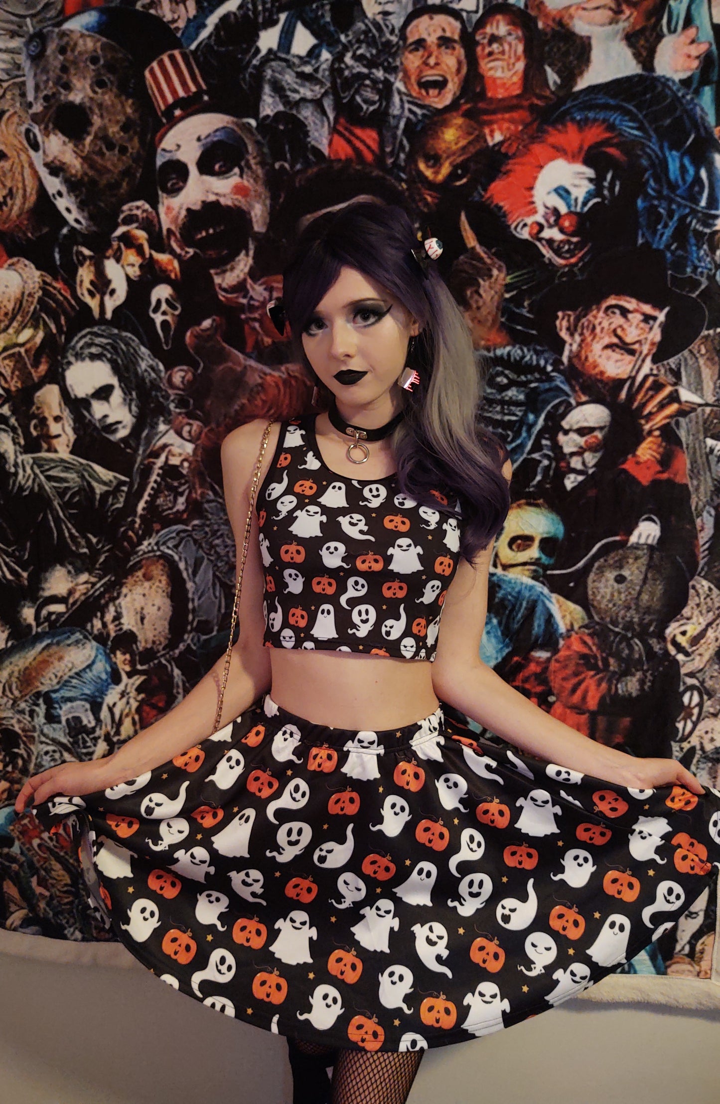 Young girl wearing a matched Halloween skirt and crop top with pumpkin ghosts desing.