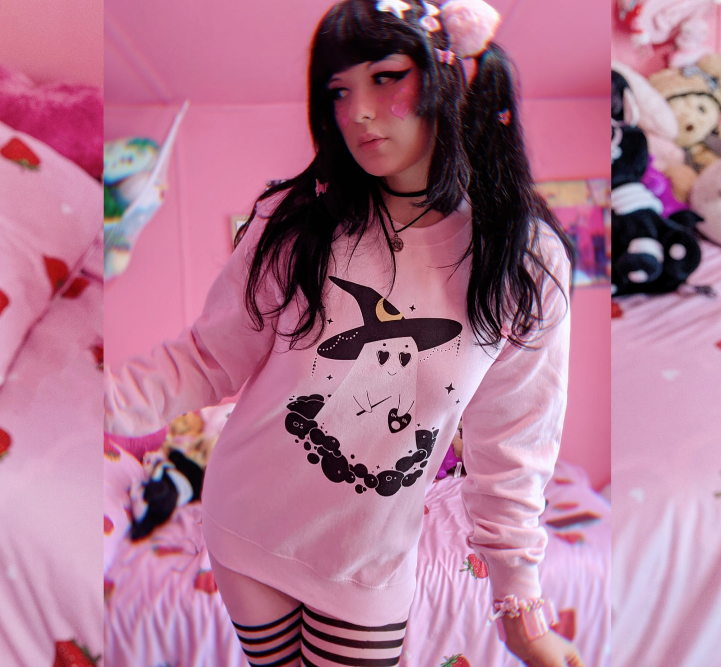 Girl modelling a pastel goth Halloween cute sweatshirt with ghost designs in pink 