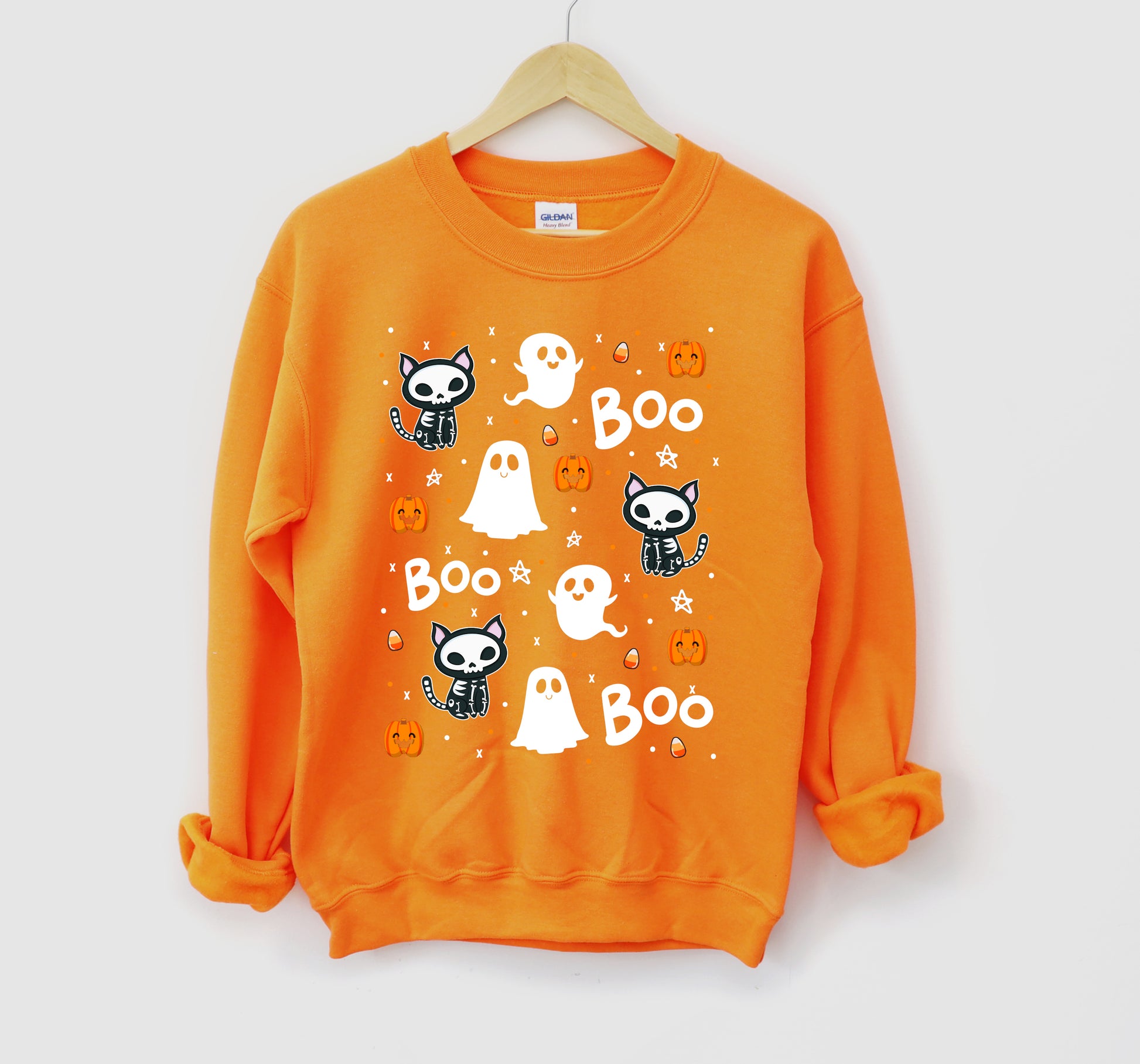 Orange sweatshirt with Halloween-themed graphics on a white background