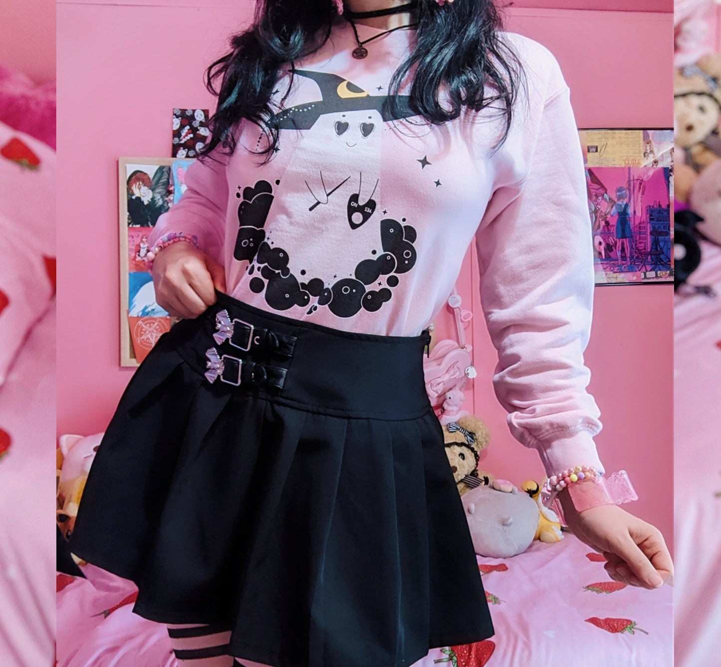 Girl modelling a pastel goth Halloween cute sweatshirt with ghost designs in pink 