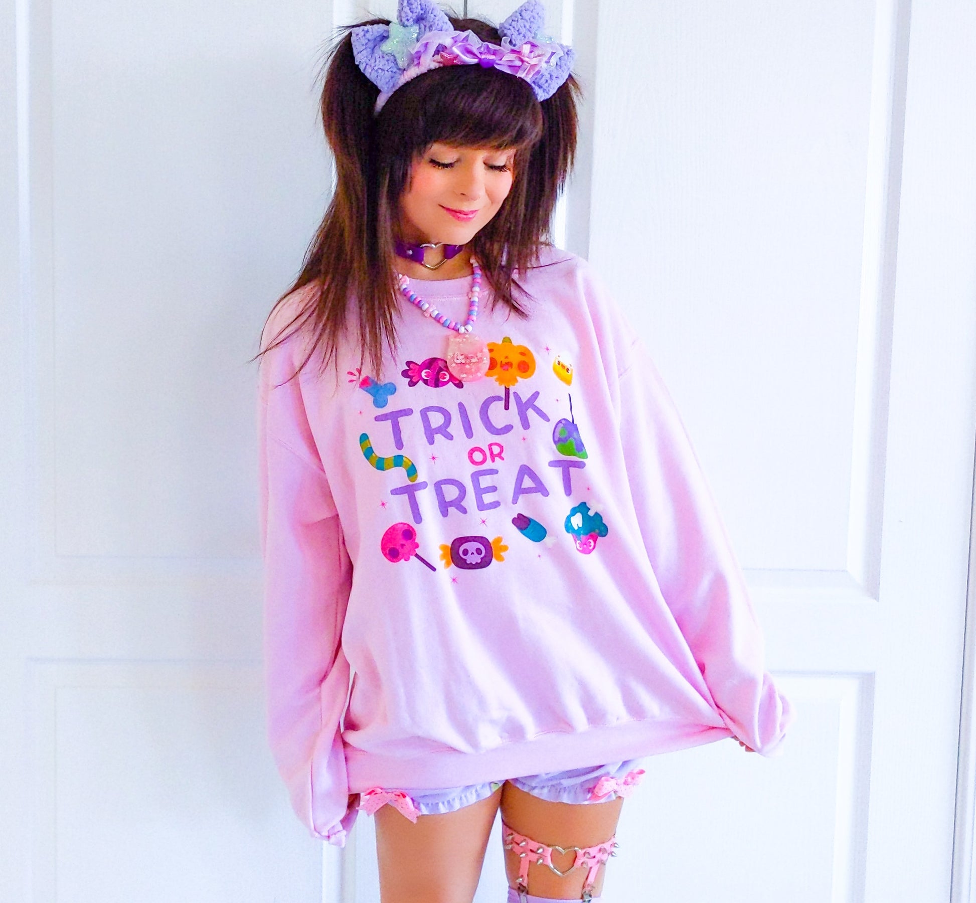 Girl modelling a Kawaii Cute Halloween sweatshirt with spooky candies design