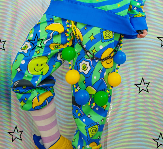 Young boy dressed in colorful Decora Kei and Kidcore fashion with vibrant pants.