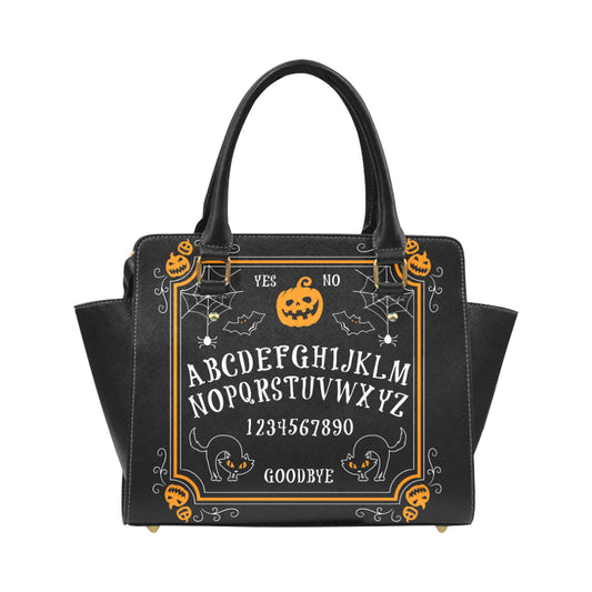 Black handbag with Halloween-themed design featuring pumpkins, cats, and the Ouija board on a white background.