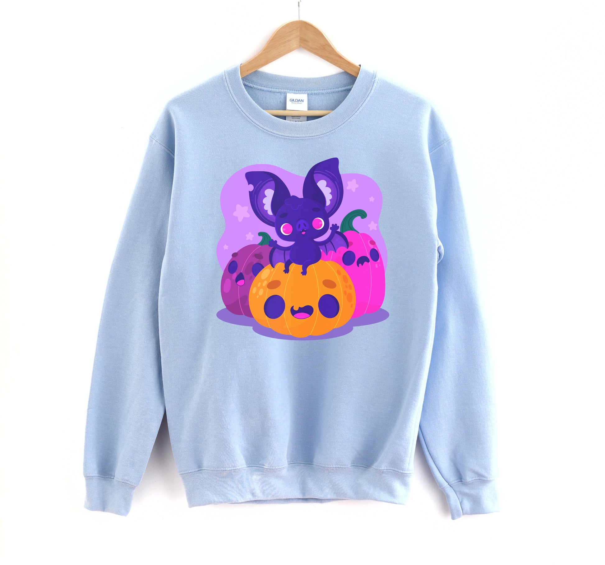 Kawaii sweatshirt with Halloween-themed graphics and bat on a white background.