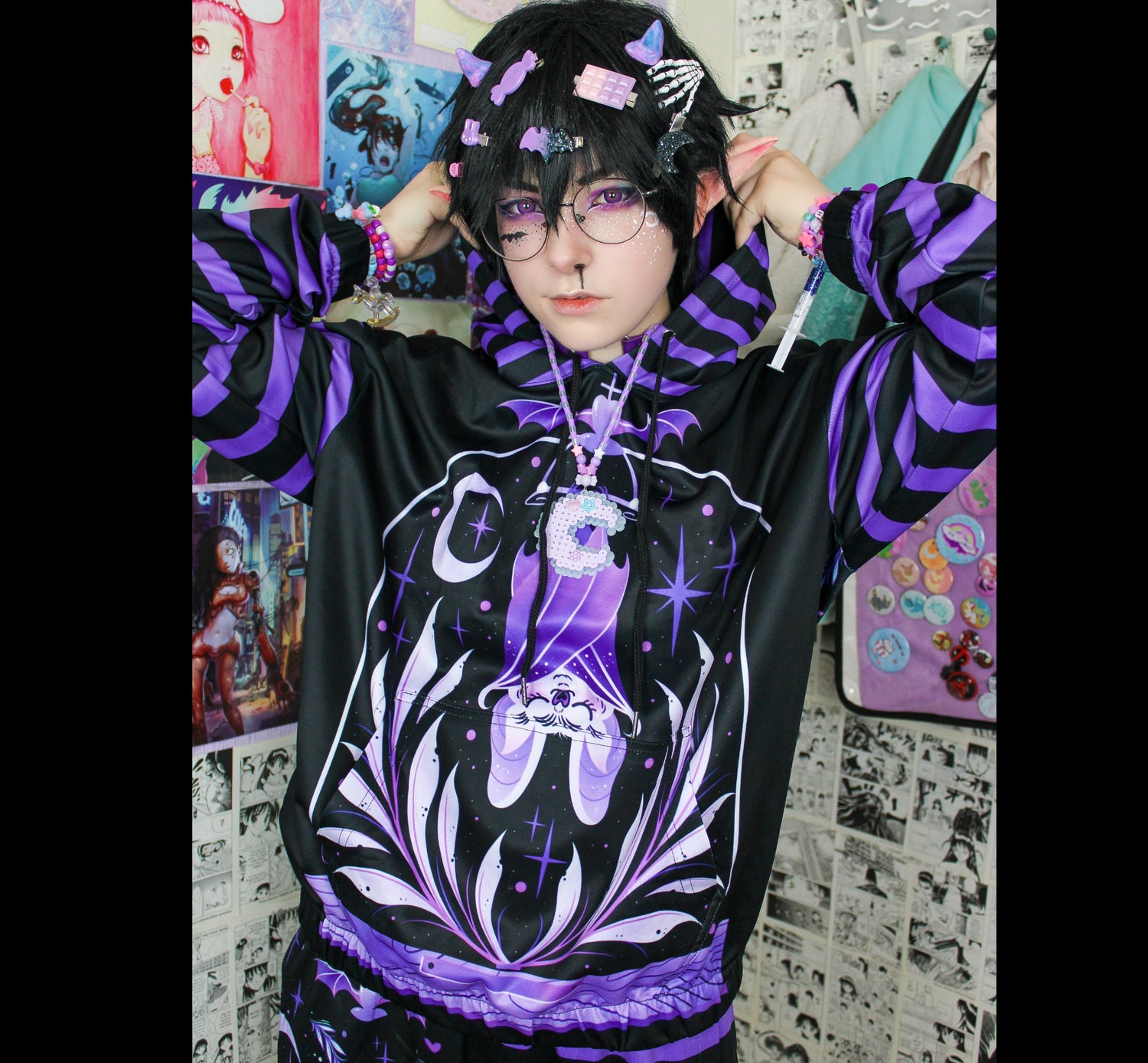 Young boy wearing a pastel goth hoodie sweatshirt with creepy bat design 
