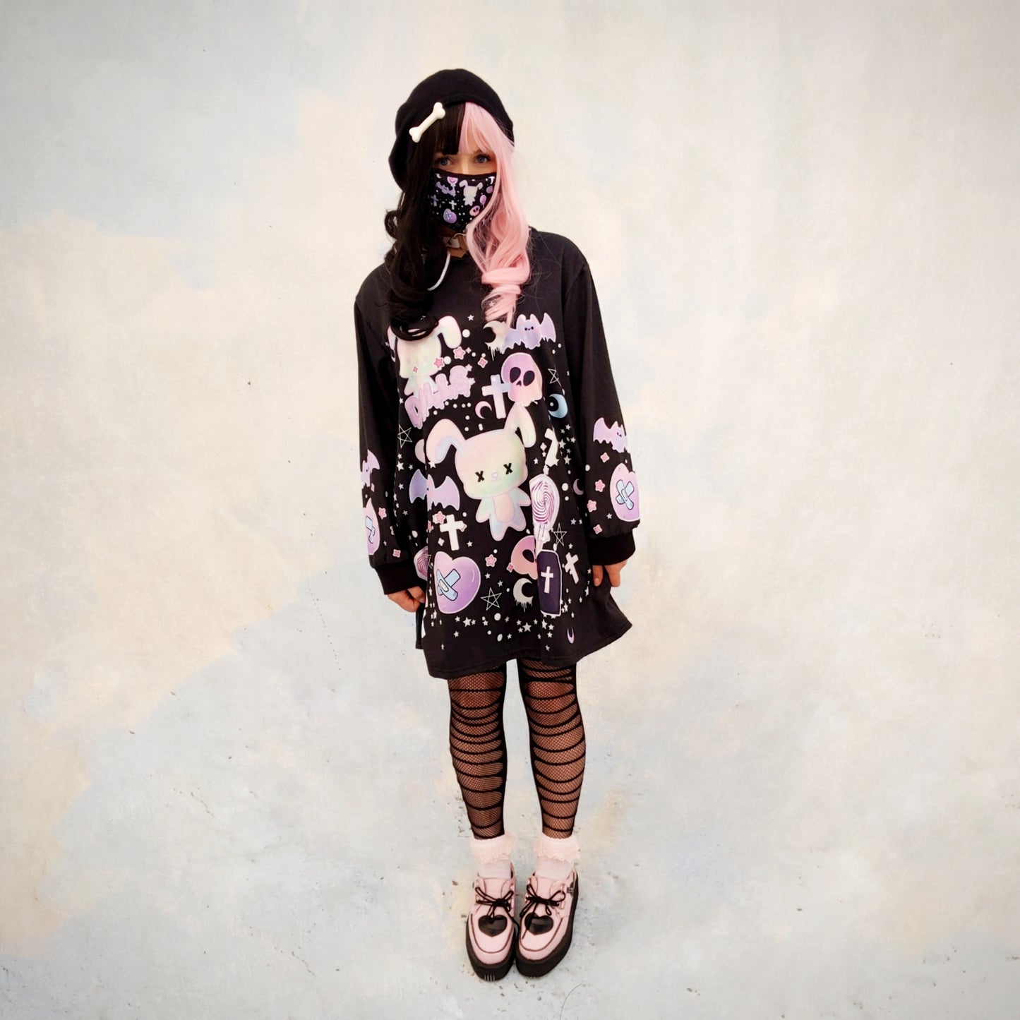 young model wearing a Pastel goth creepy cute bunny skull Halloween hoodie dress