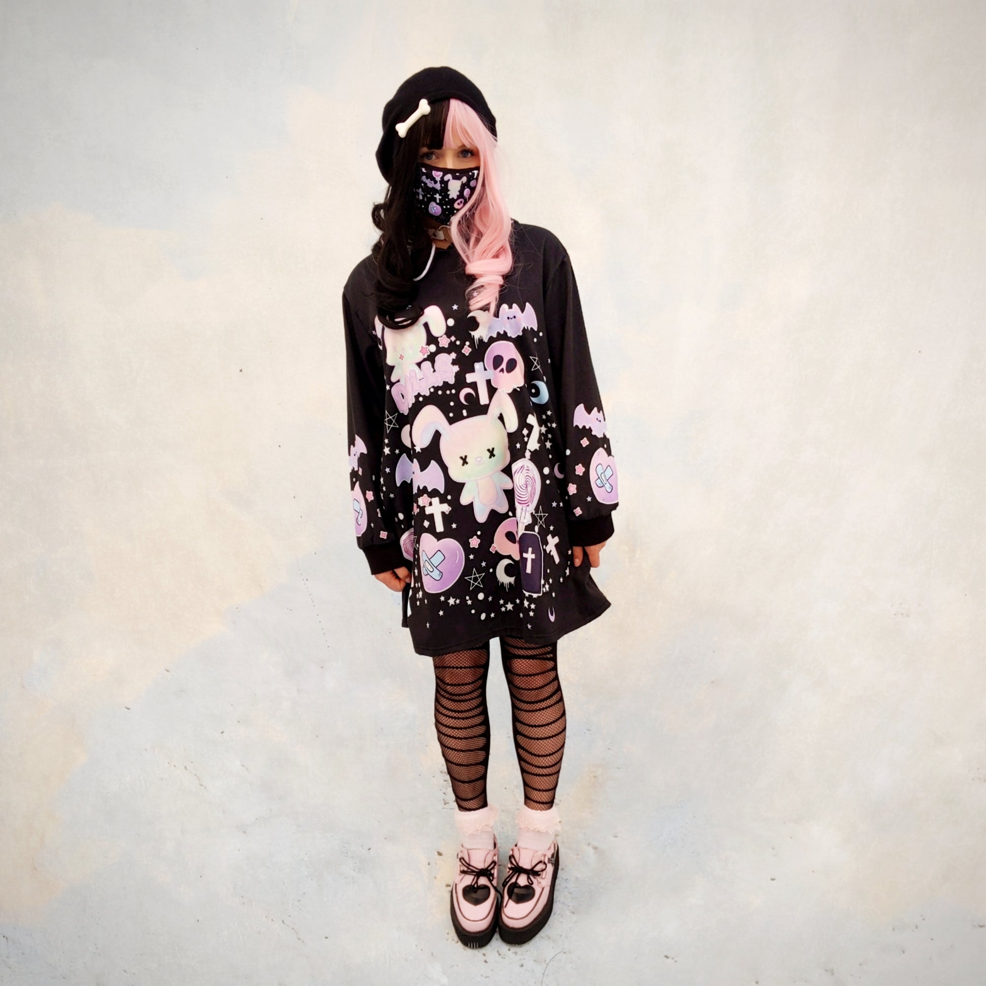 young model wearing a Pastel goth creepy cute bunny skull Halloween hoodie dress