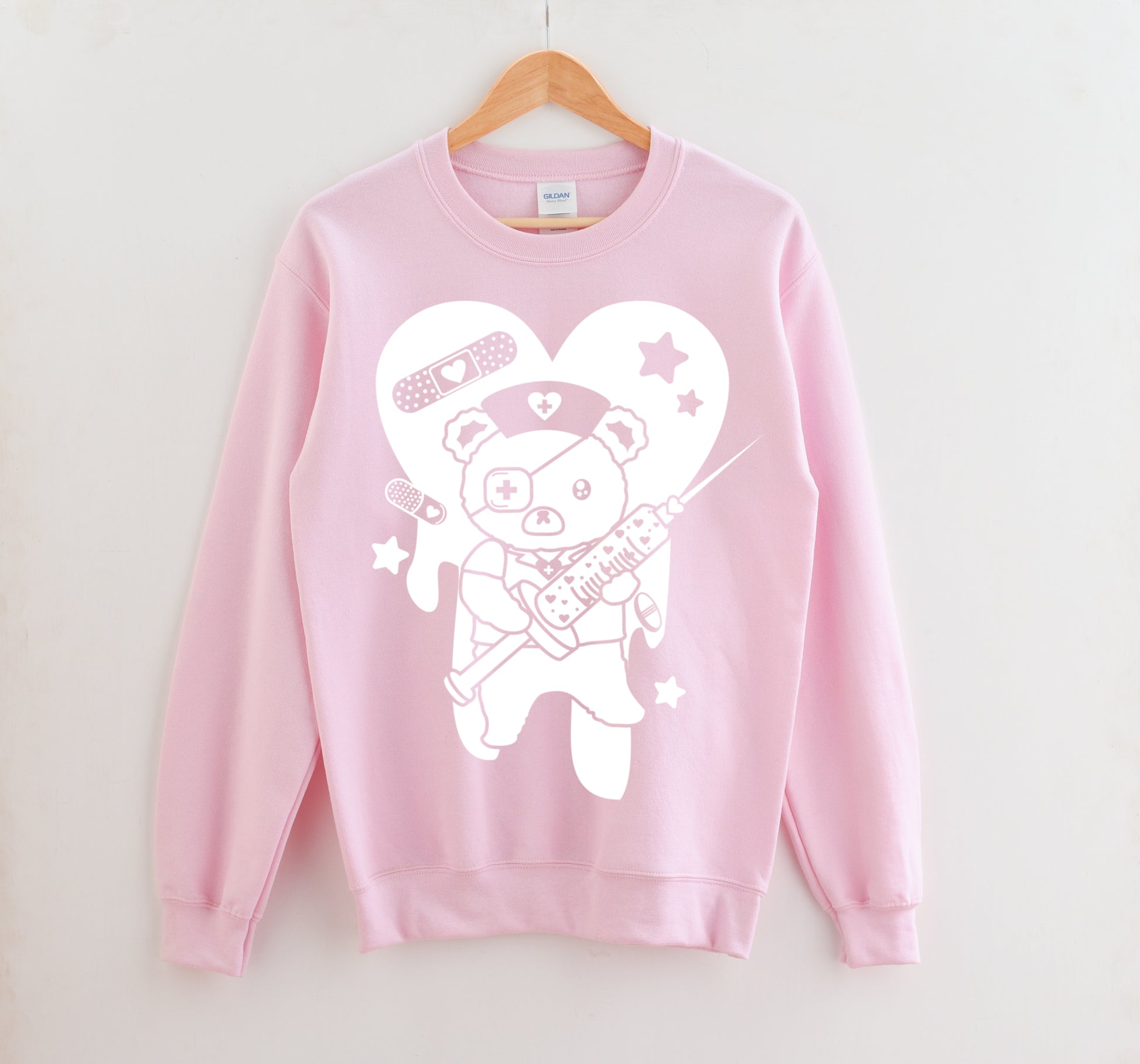 Pink Menhera Kei Bear Band Aid kawaii aesthetic sweatshirt displayed on clean background.