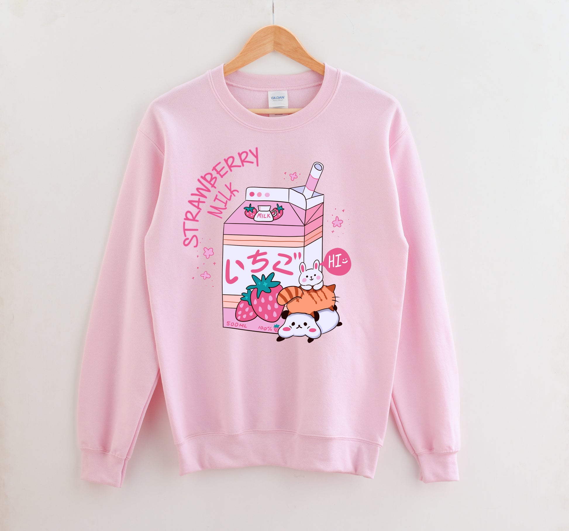 Pink pastel kawaii sweatshirt displayed on clean white background.