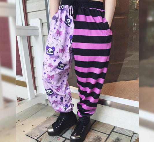 Youth model wearing a kawaii pastel goth cat joggers