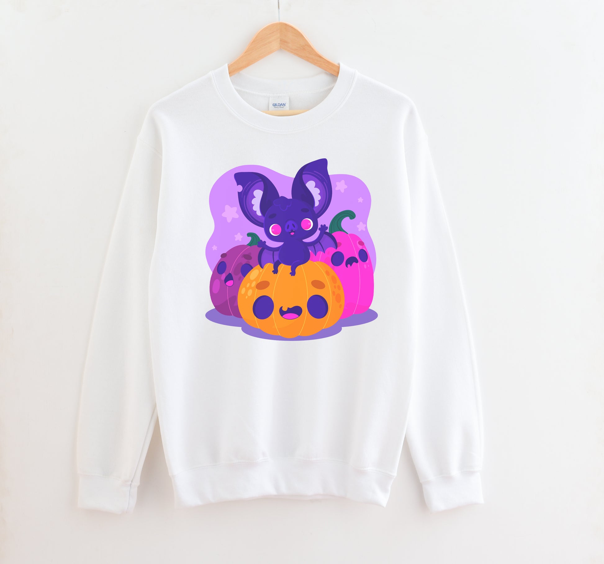 Kawaii sweatshirt with Halloween-themed graphics and bat on a white background.