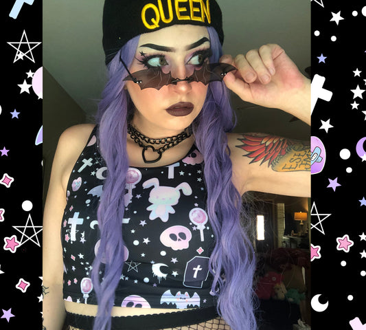 Teen girl dressed in pastel goth fashion with a spooky-cute graphic crop top 