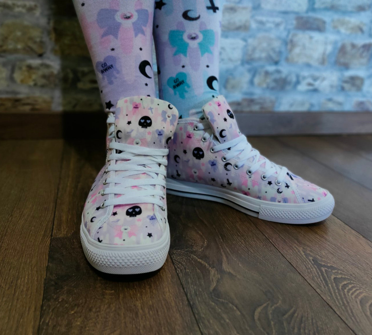 Model wearing stylish pink pastel goth shoes with a playful design