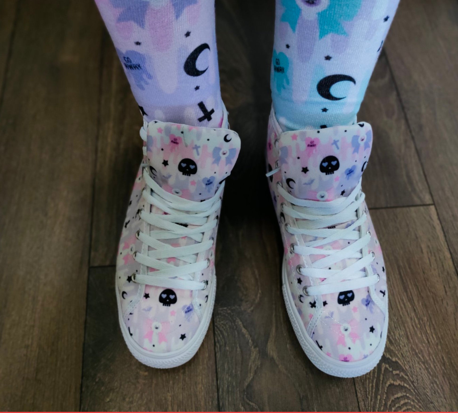 Model wearing stylish pink pastel goth shoes with a playful design