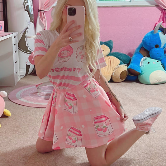 Youthful model wearing a cute Yume kawaii Fairy Kei Pastel pink strawberry skirt