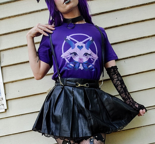 Teen girl dressed in pastel goth fashion with a spooky-cute graphic tee