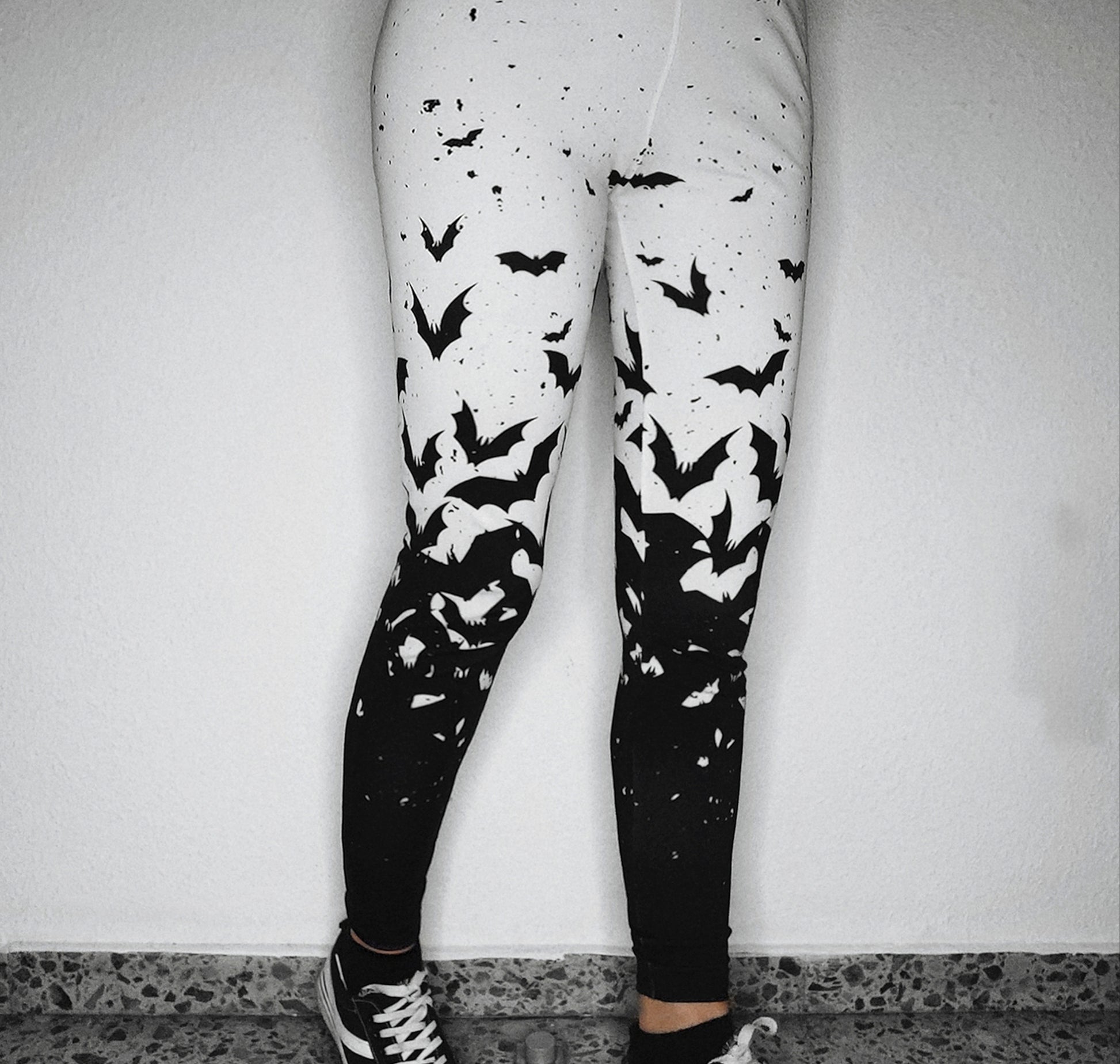 Young girl wearing a pastel goth leggings with Black and White Bats design
