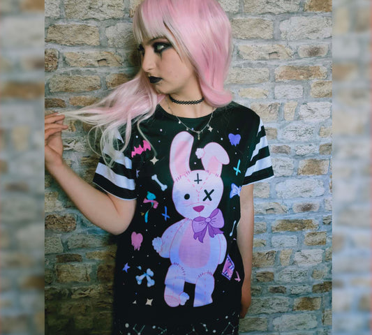 Teen girl dressed in  kawaii goth fashion with a spooky-cute graphic t-shirt