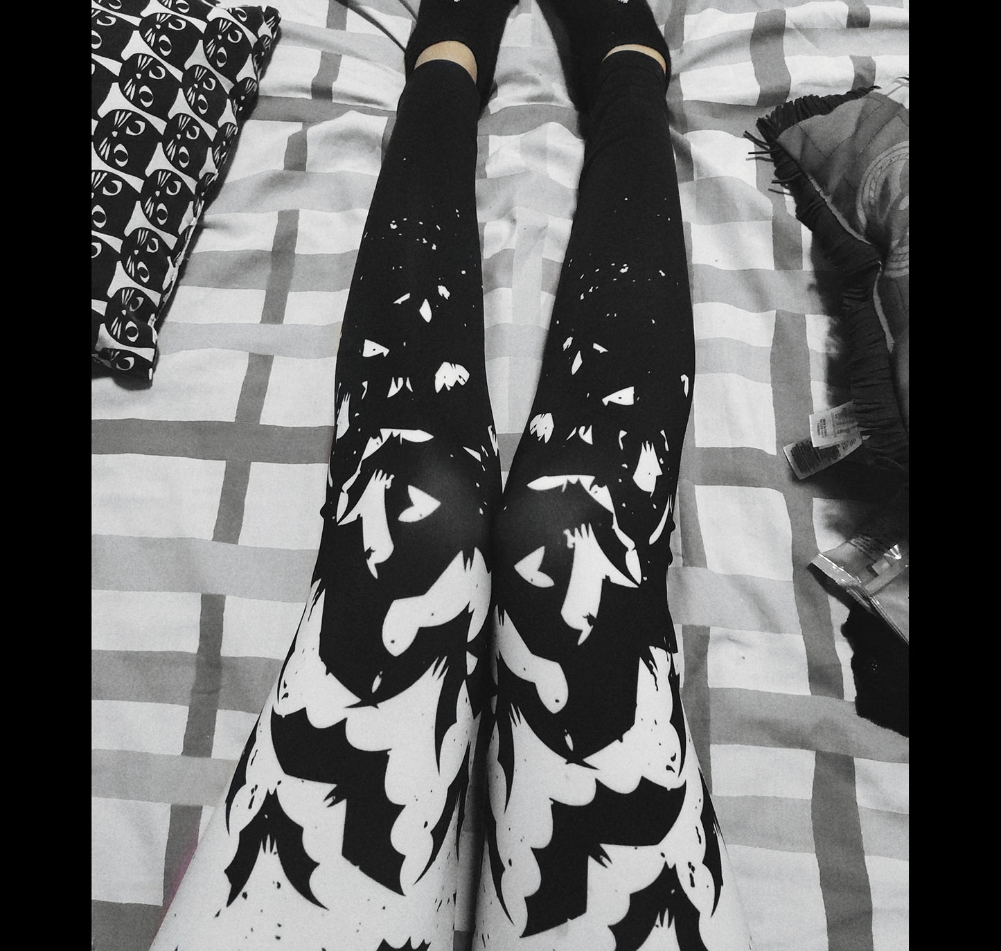 Young girl wearing a pastel goth leggings with Black and White Bats design