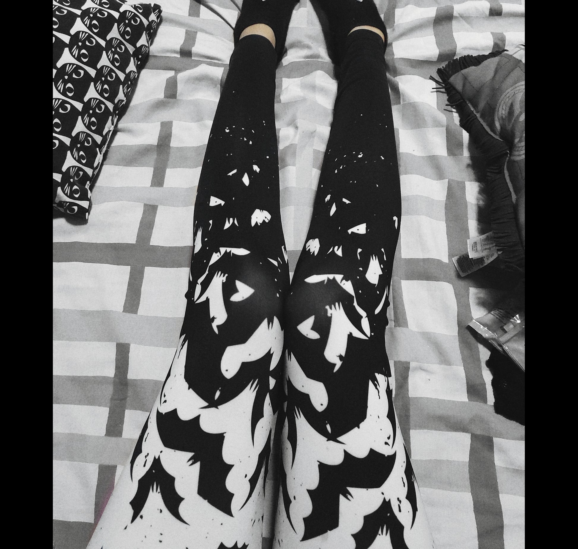 Young girl wearing a pastel goth leggings with Black and White Bats design