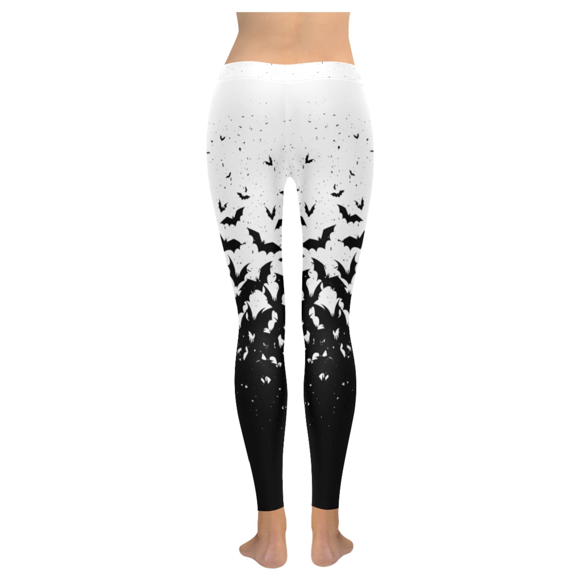 White and black pastel goth leggings displayed on clean white background.