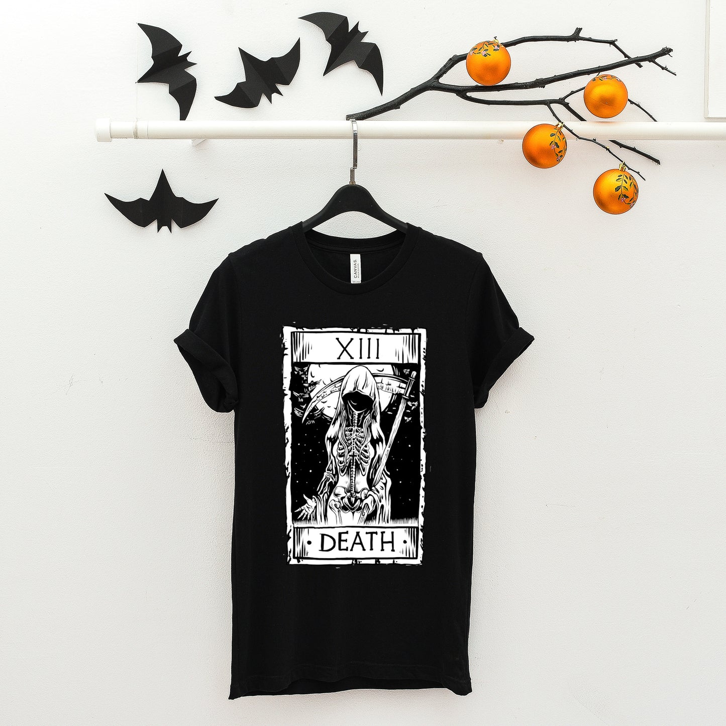 goth t-shirt with death tarot card and black accessories on white background