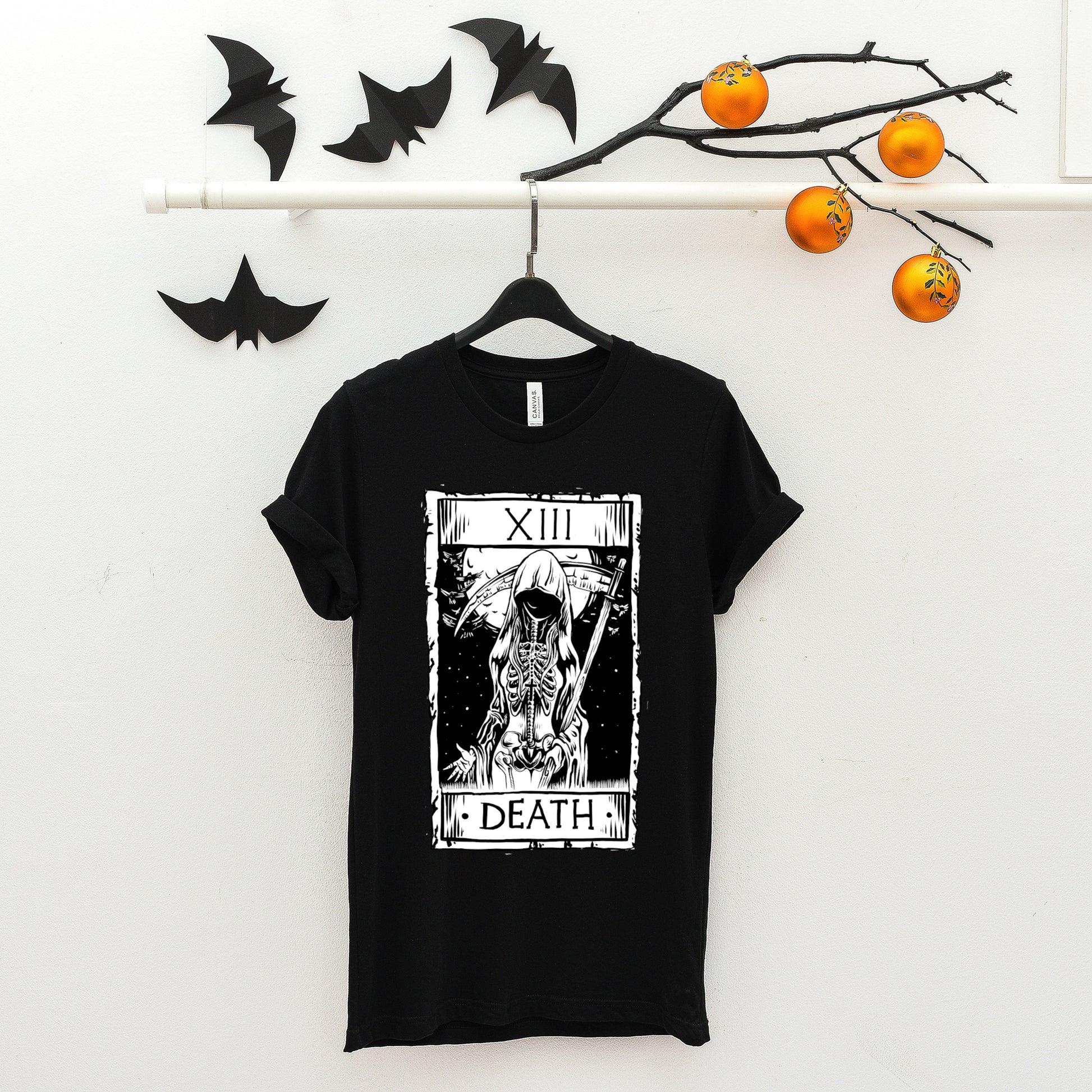 goth t-shirt with death tarot card and black accessories on white background