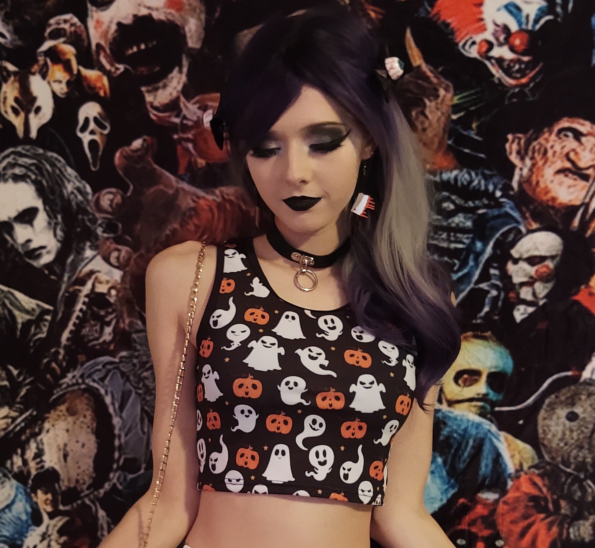 Young girl wearing a pastel goth Halloween crop top with pumpkin ghosts desing.