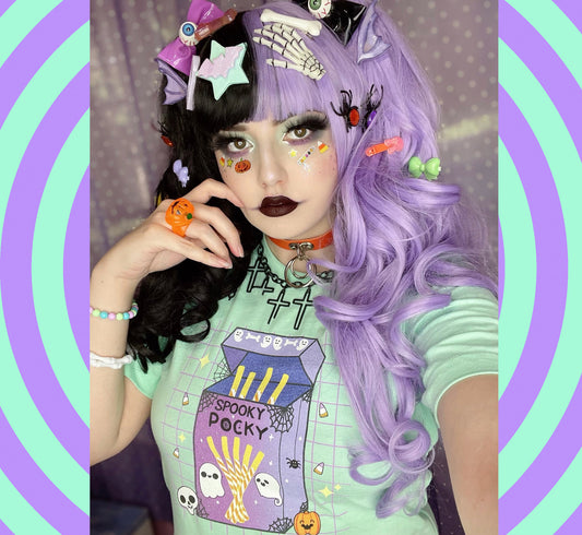 Girl with purple hair and Halloween-themed t-shirt against a colorful spiral background