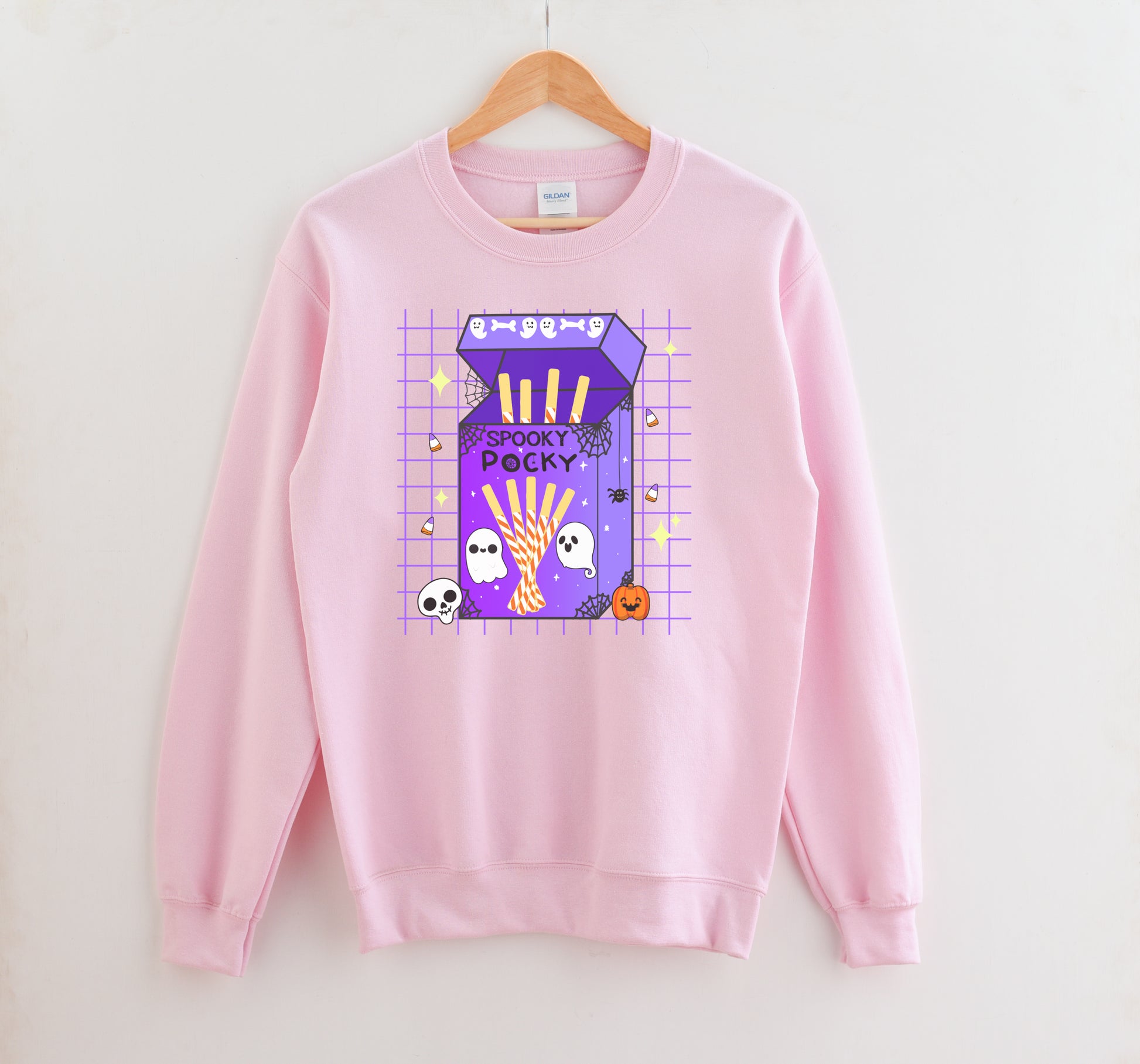 Pink sweatshirt with a colorful graphic on a hanger against a white background