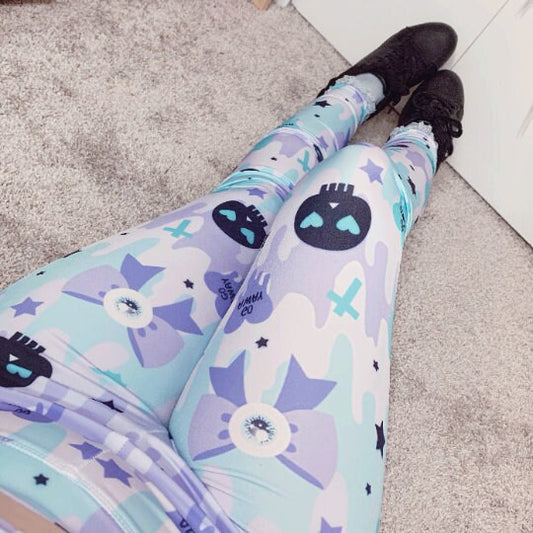 Young girl wearing pastel goth  cute and creepy leggings with soft colors 