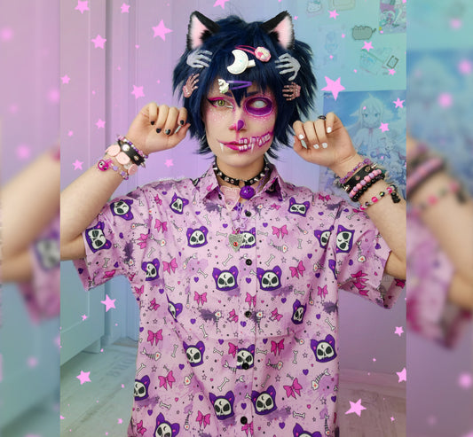 Model wearing a pastel goth button up shirt with  cute cat designs.