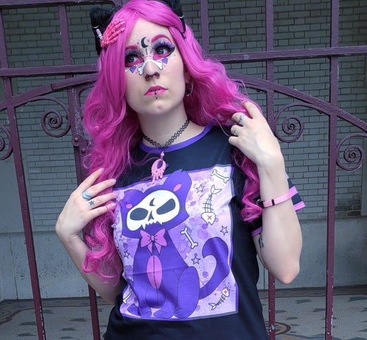 Girl modeling a pastel goth t-shirt with cat skull design