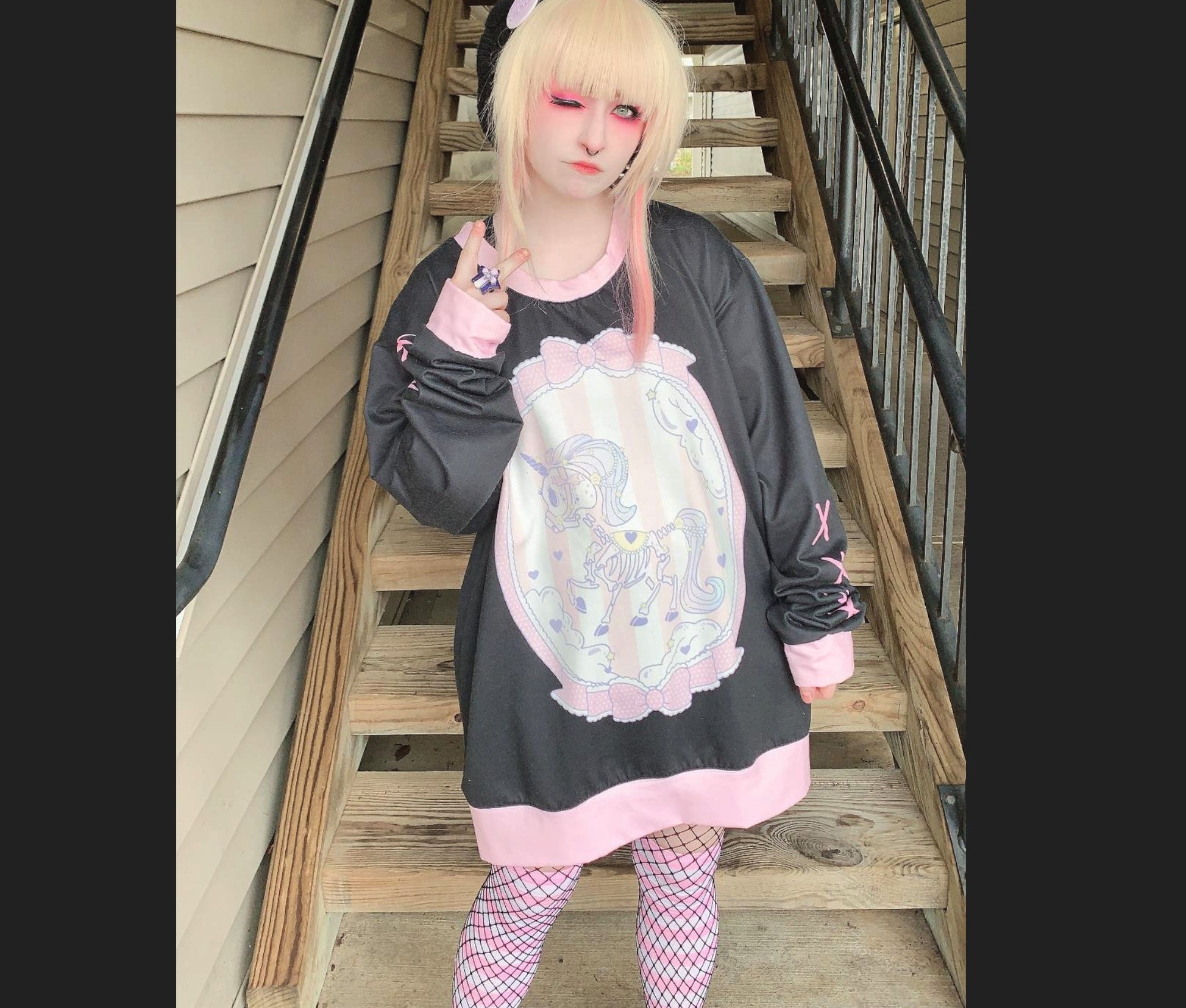 model wearing a pastel goth yami kawaii unicorn skeleton oversized sweatshirt