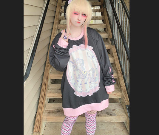 model wearing a pastel goth yami kawaii unicorn skeleton oversized sweatshirt