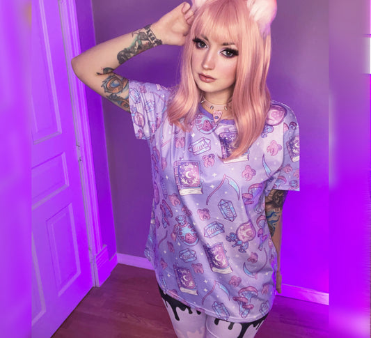 Teen girl dressed in pastel goth fashion with a spooky-cute graphic tee
