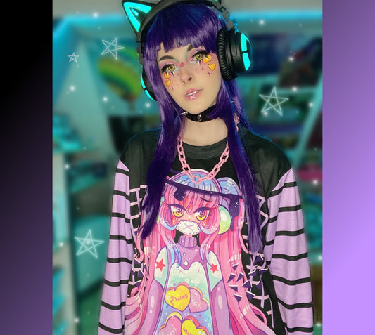 Young girl wearing a pastel goth sweatshirt with soft colors and creepy  design.