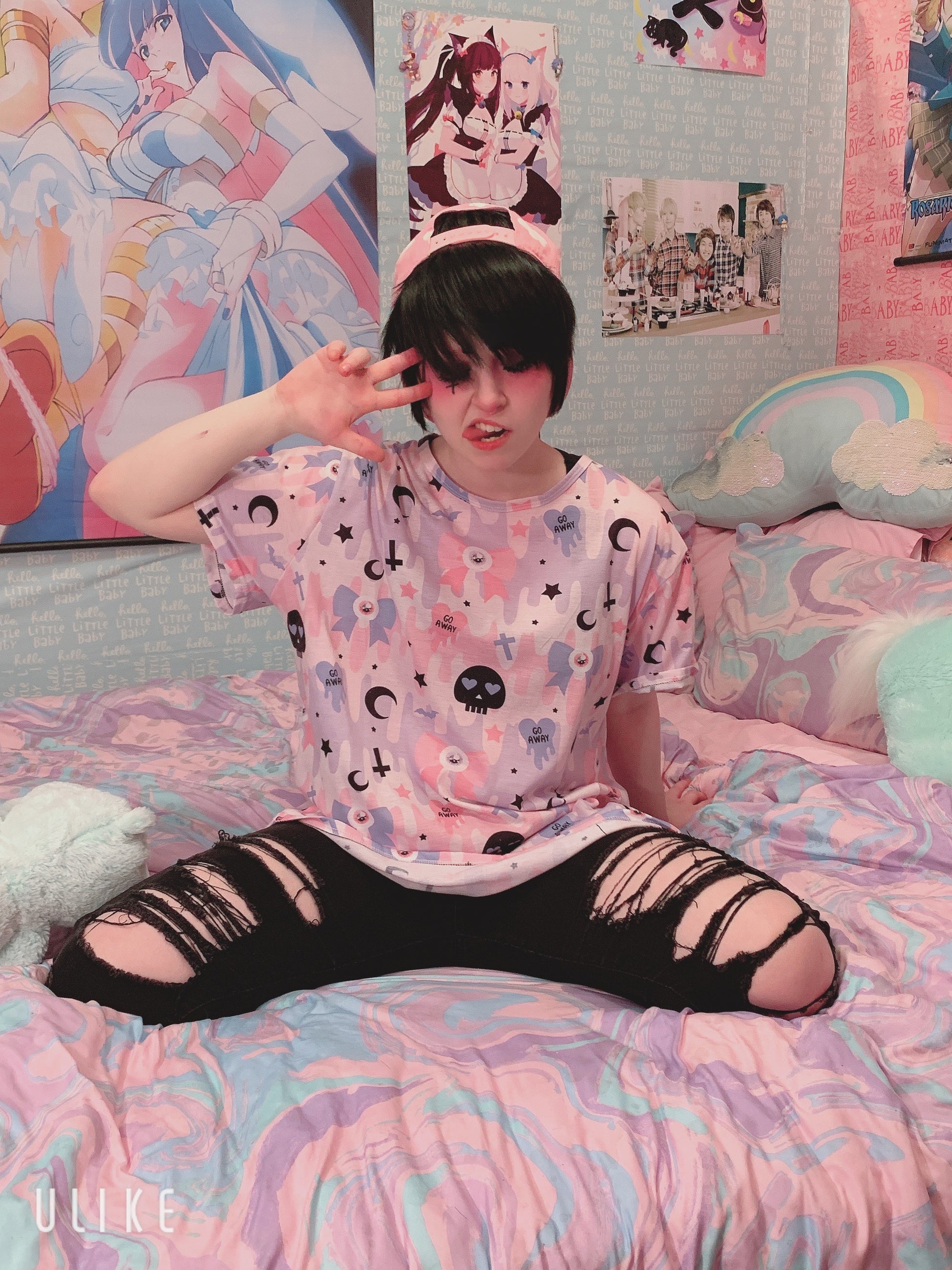Young girl wearing a pastel goth t-shirt with soft colors and creepy cute skull design.