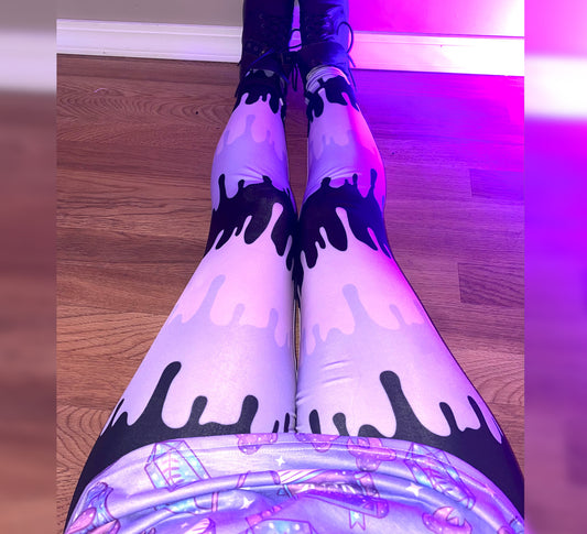 Girl modeling pastel goth kawaii cute creepy leggings with pink purple black