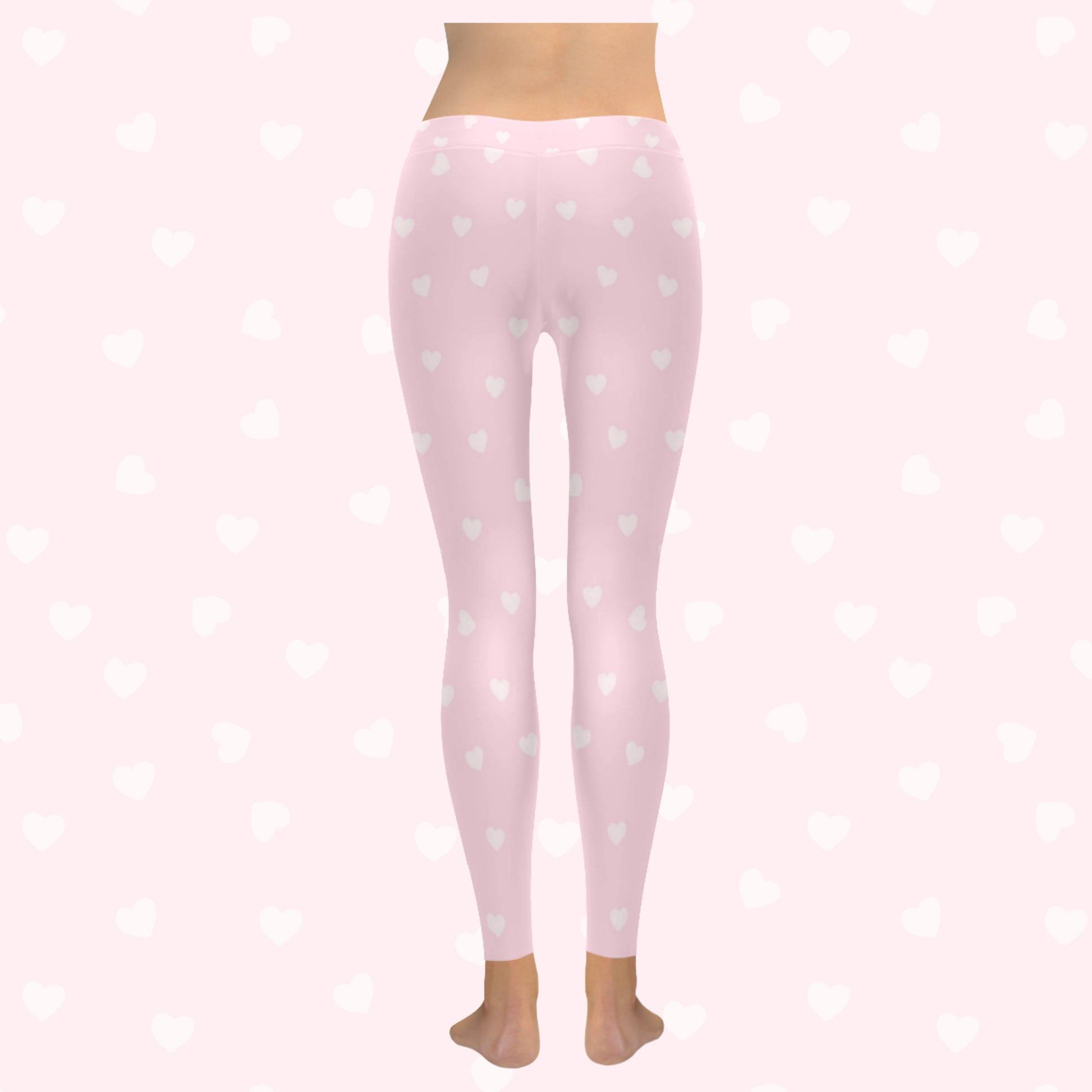 model wearing pink heart yume kawaii leggings on pink heart  background
