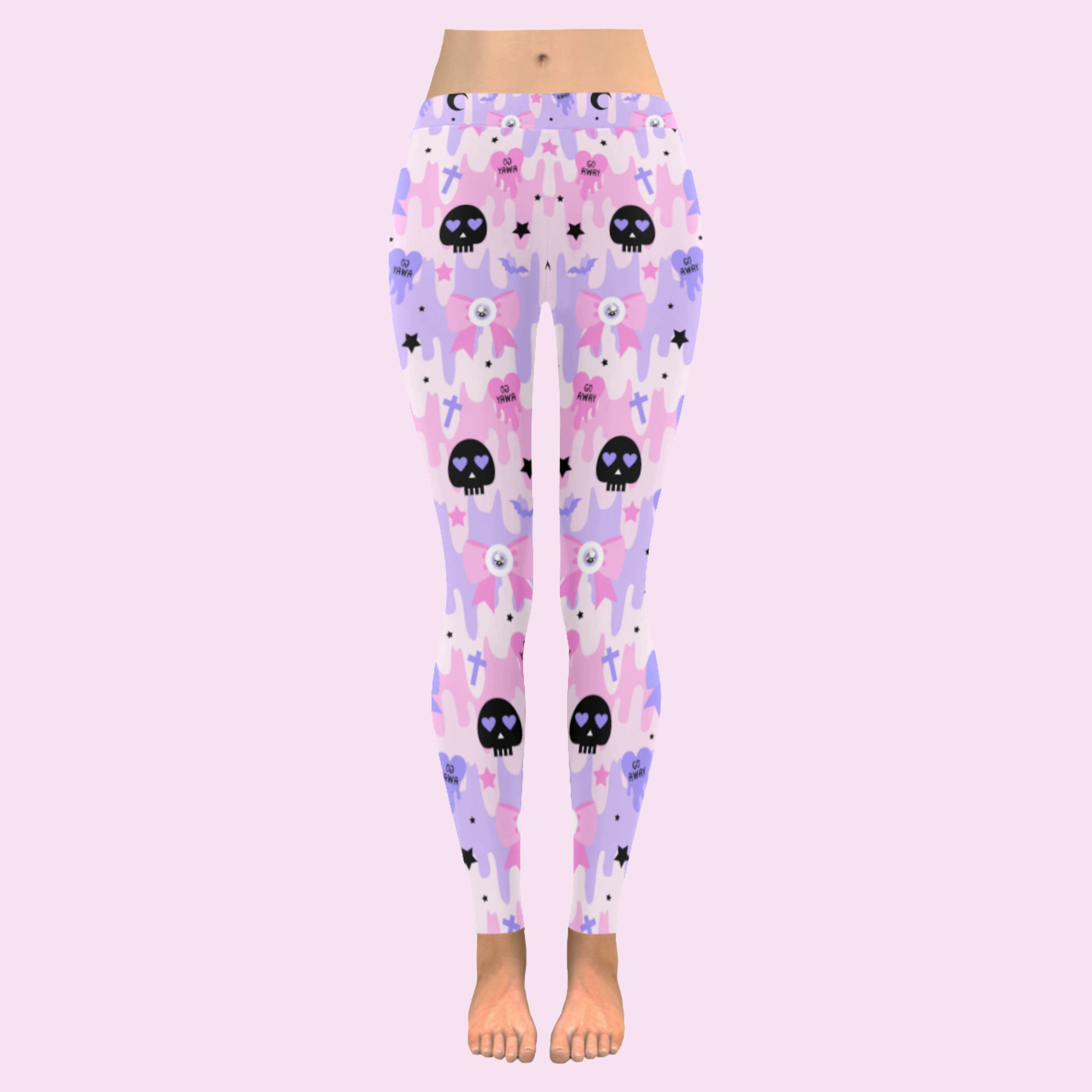 pink pastel goth skull leggings displayed on a pink background.