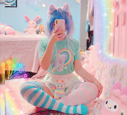 Cute girl modeling a kawaii aesthetic t-shirt featuring playful, pastel artwork