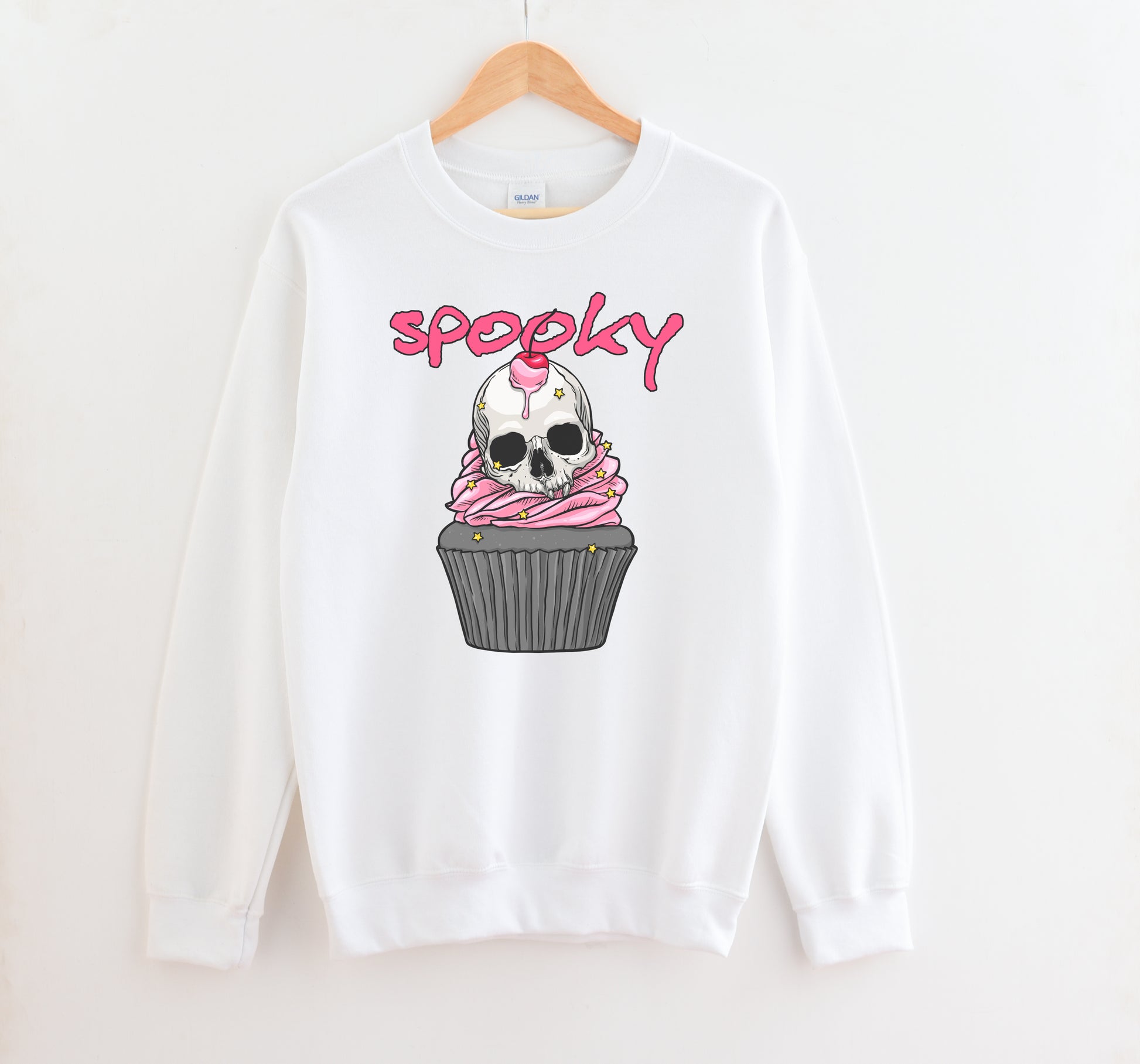 Kawaii Goth sweatshirt with Halloween-themed graphics of a skull cupcake on a white background.