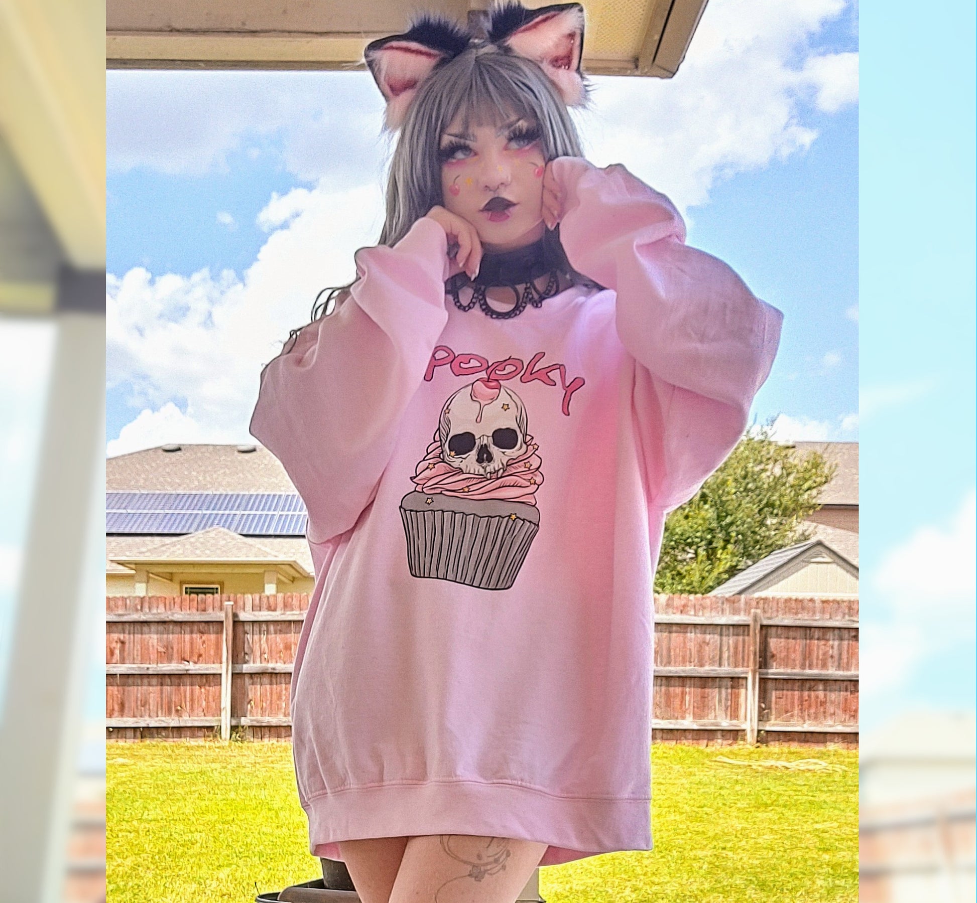 Girl modelling a Kawaii Goth Halloween sweatshirt with spooky skull design
