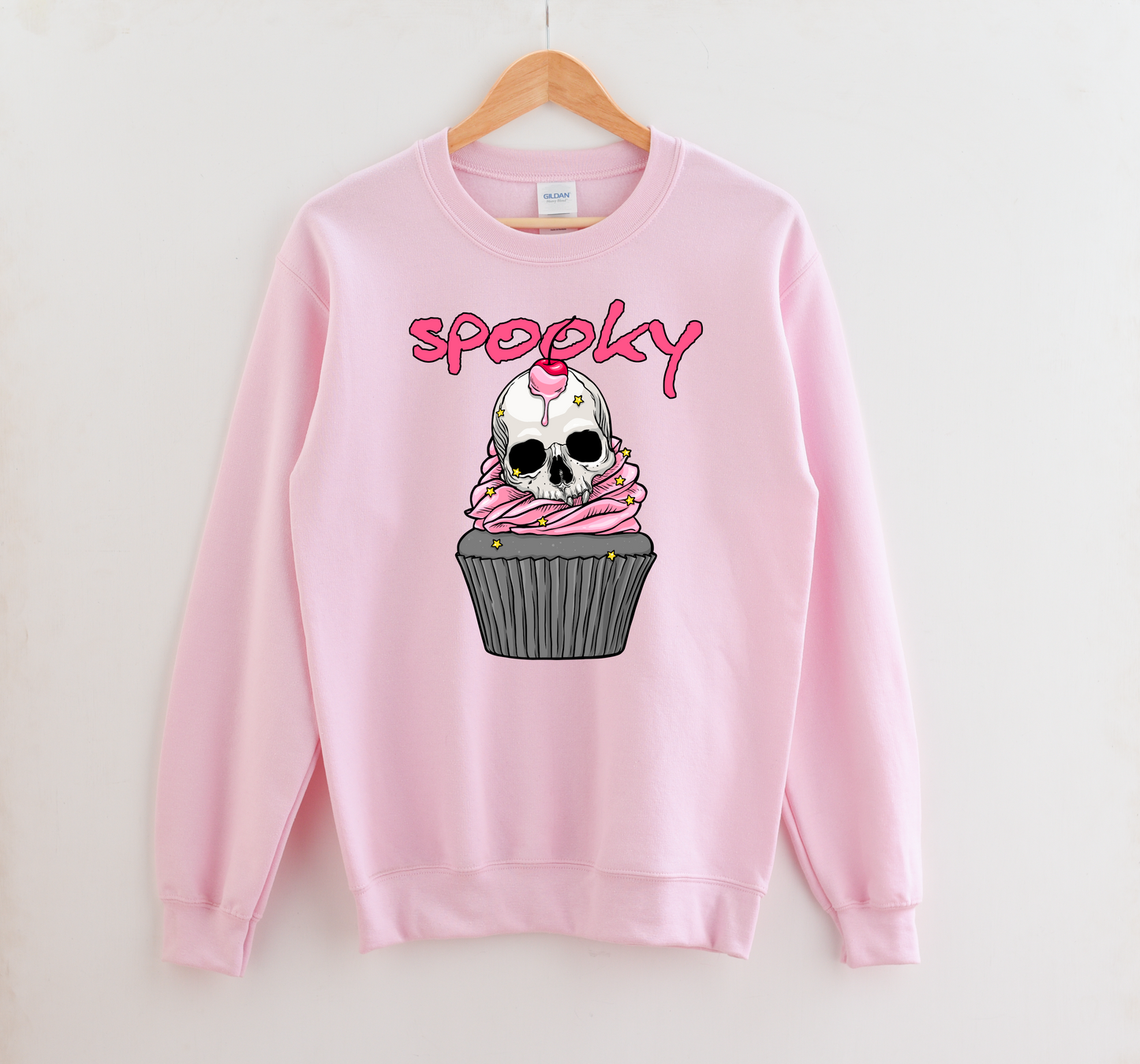 Kawaii Goth sweatshirt with Halloween-themed graphics of a skull cupcake on a white background.