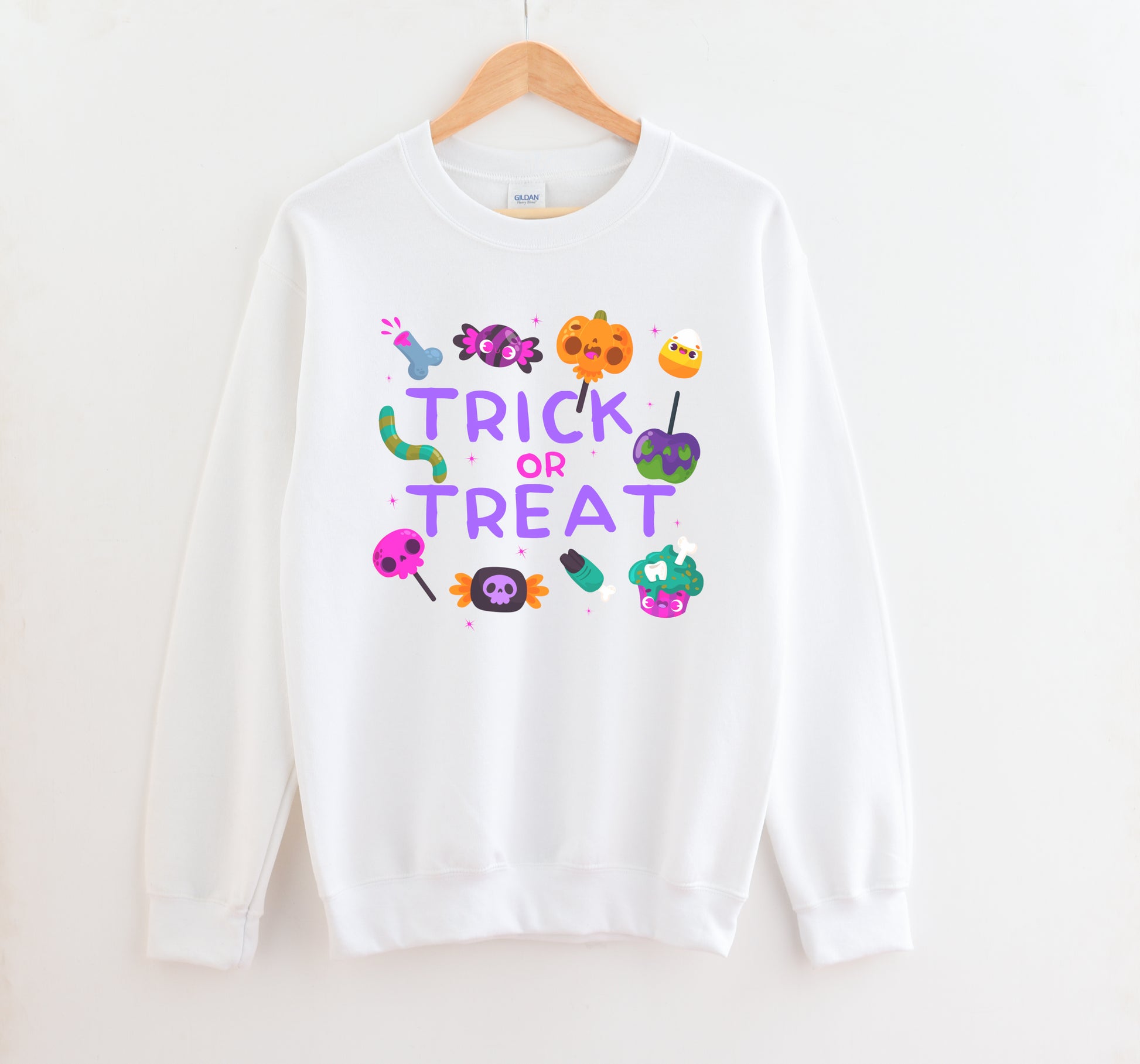 White sweatshirt with 'Trick or Treat' text and Halloween-themed graphics on a white background