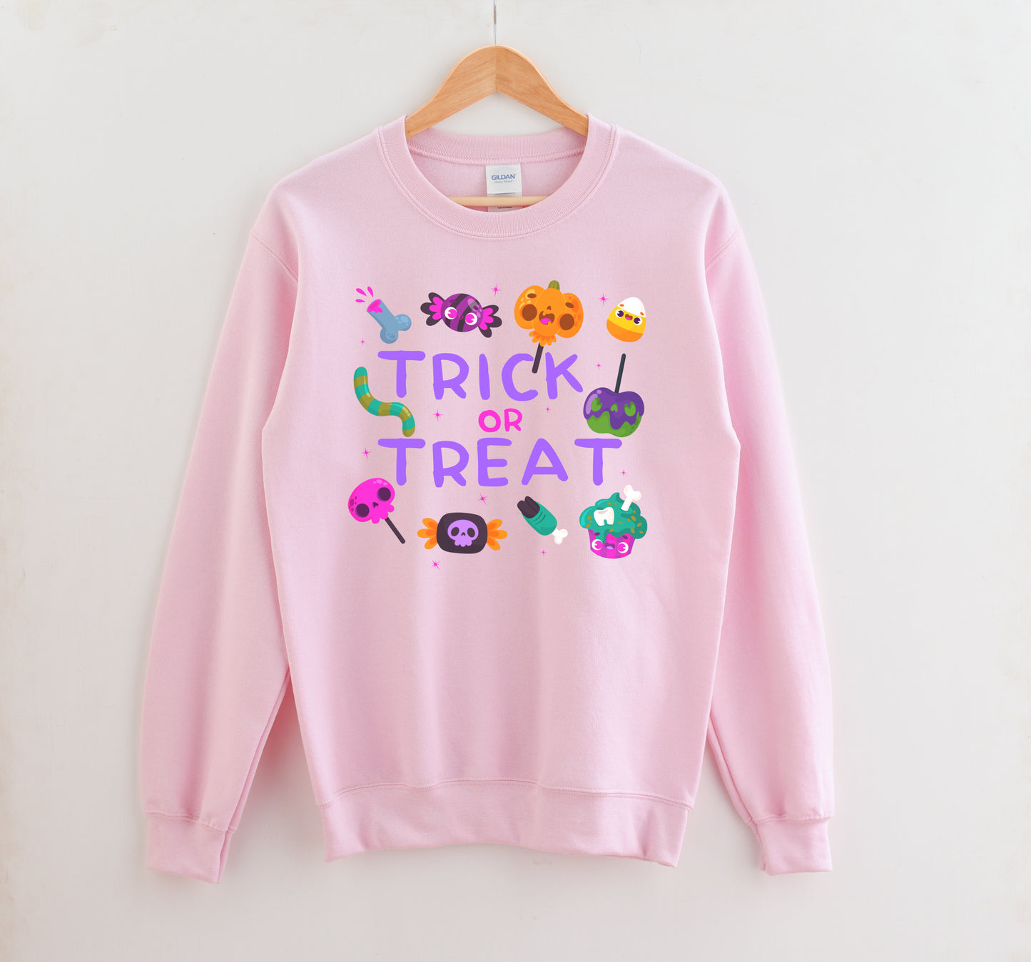 Pink Halloween Trick or Treat kawaii sweatshirt displayed on clean white background