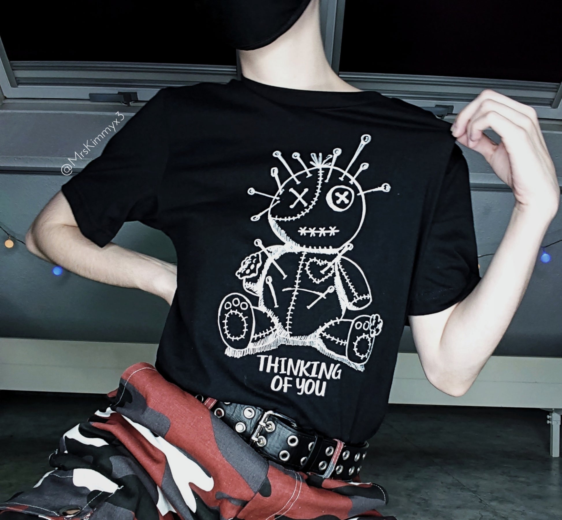 Girl modelling a goth t-shirt with voodoo design